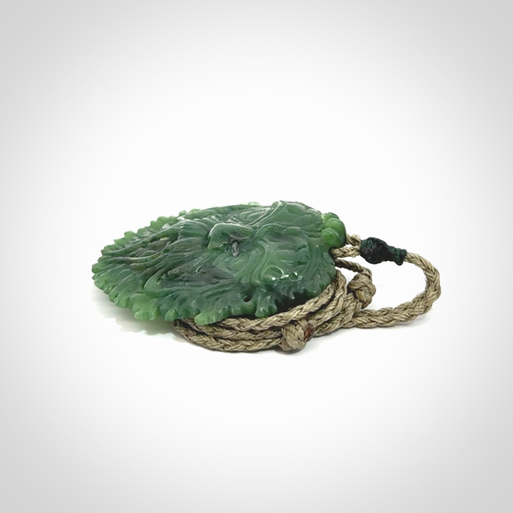 This picture shows a large hand carved forest man face pendant. The cord is hand plaited and adjustable.