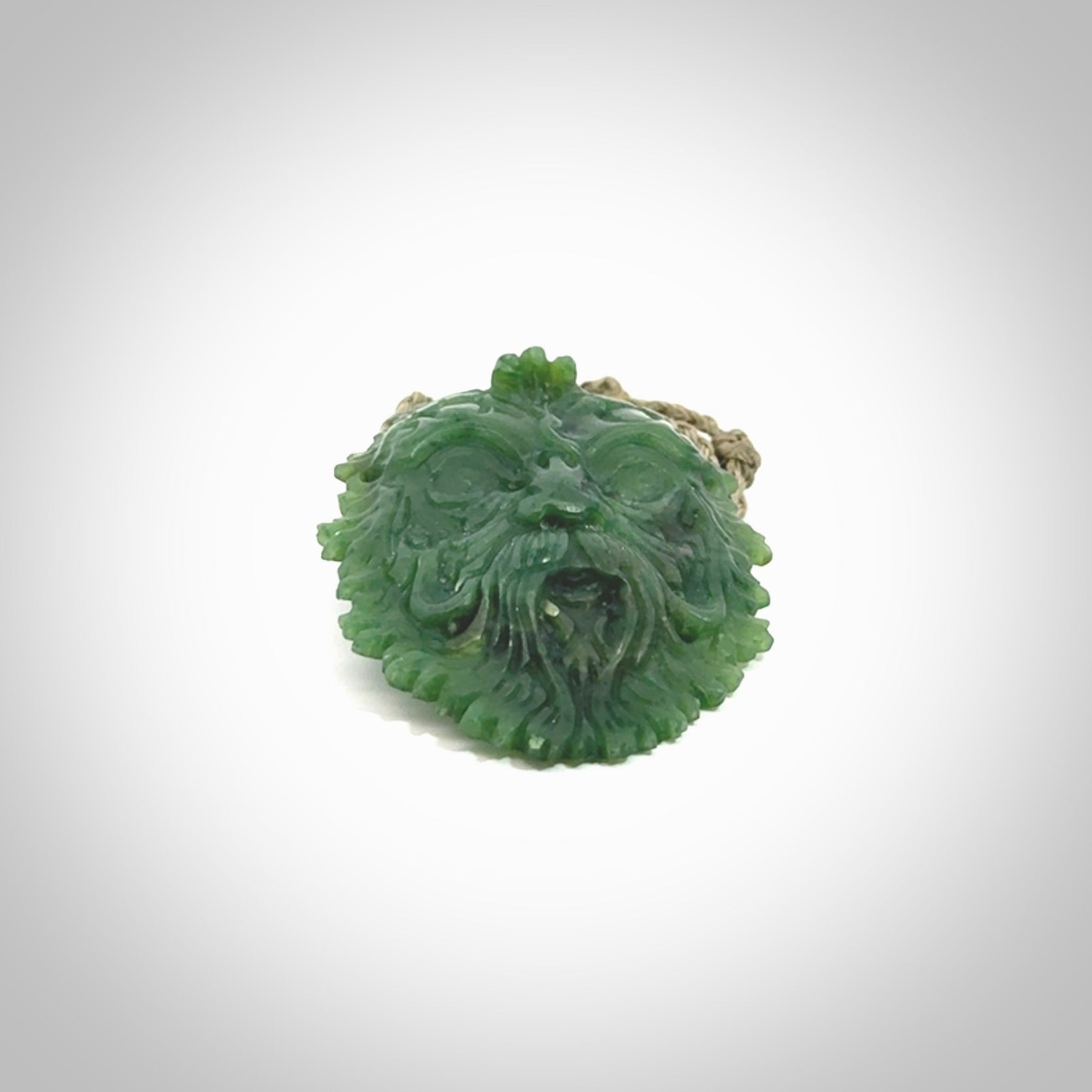 This picture shows a large hand carved forest man face pendant. The cord is hand plaited and adjustable.
