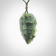 This picture shows a large hand carved forest man face pendant. It is a light green colour which is quite beautiful. Although a large piece, it is a wonderful, delicate piece of jewellery. The cord is hand plaited and adjustable so that you can position the pendant where it suits you best. Delivery is free worldwide.