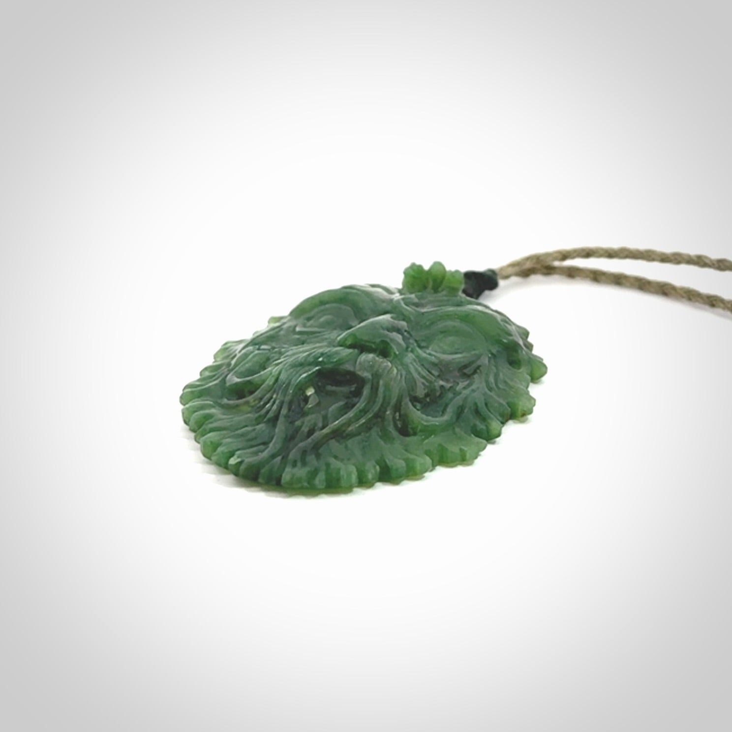 This picture shows a large hand carved forest man face pendant. The cord is hand plaited and adjustable.