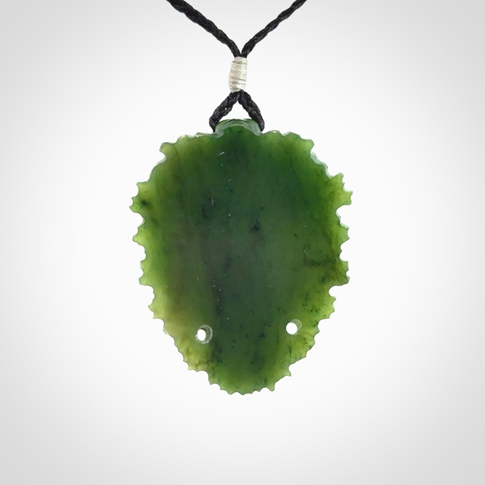 This picture shows a large hand carved forest man face pendant. The cord is hand plaited and adjustable.