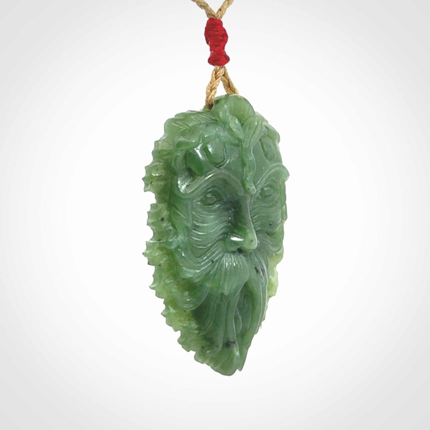 This picture shows a large hand carved forest man face pendant. The cord is hand plaited and adjustable.