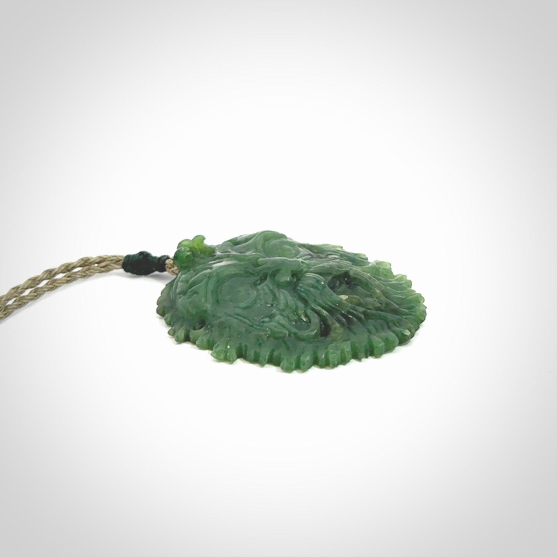This picture shows a large hand carved forest man face pendant. The cord is hand plaited and adjustable.