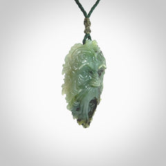 This picture shows a large hand carved forest man face pendant. It is a light green colour which is quite beautiful. Although a large piece, it is a wonderful, delicate piece of jewellery. The cord is hand plaited and adjustable so that you can position the pendant where it suits you best. Delivery is free worldwide.