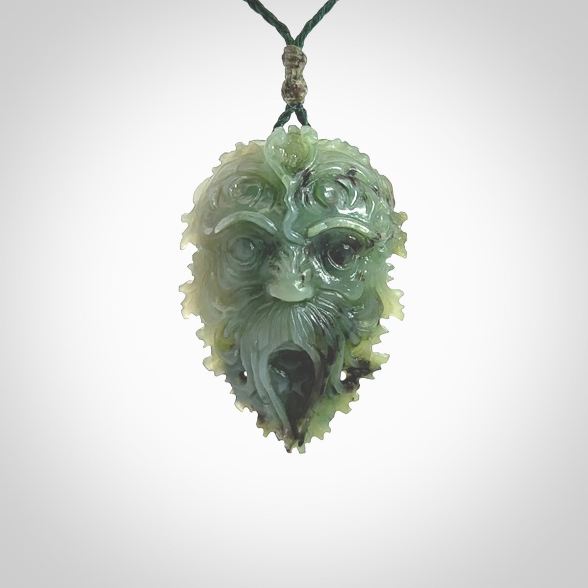 This picture shows a large hand carved forest man face pendant. It is a light green colour which is quite beautiful. Although a large piece, it is a wonderful, delicate piece of jewellery. The cord is hand plaited and adjustable so that you can position the pendant where it suits you best. Delivery is free worldwide.