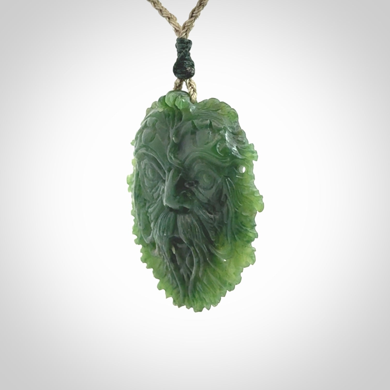 This picture shows a large hand carved forest man face pendant. The cord is hand plaited and adjustable.