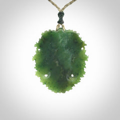 This picture shows a large hand carved forest man face pendant. The cord is hand plaited and adjustable.