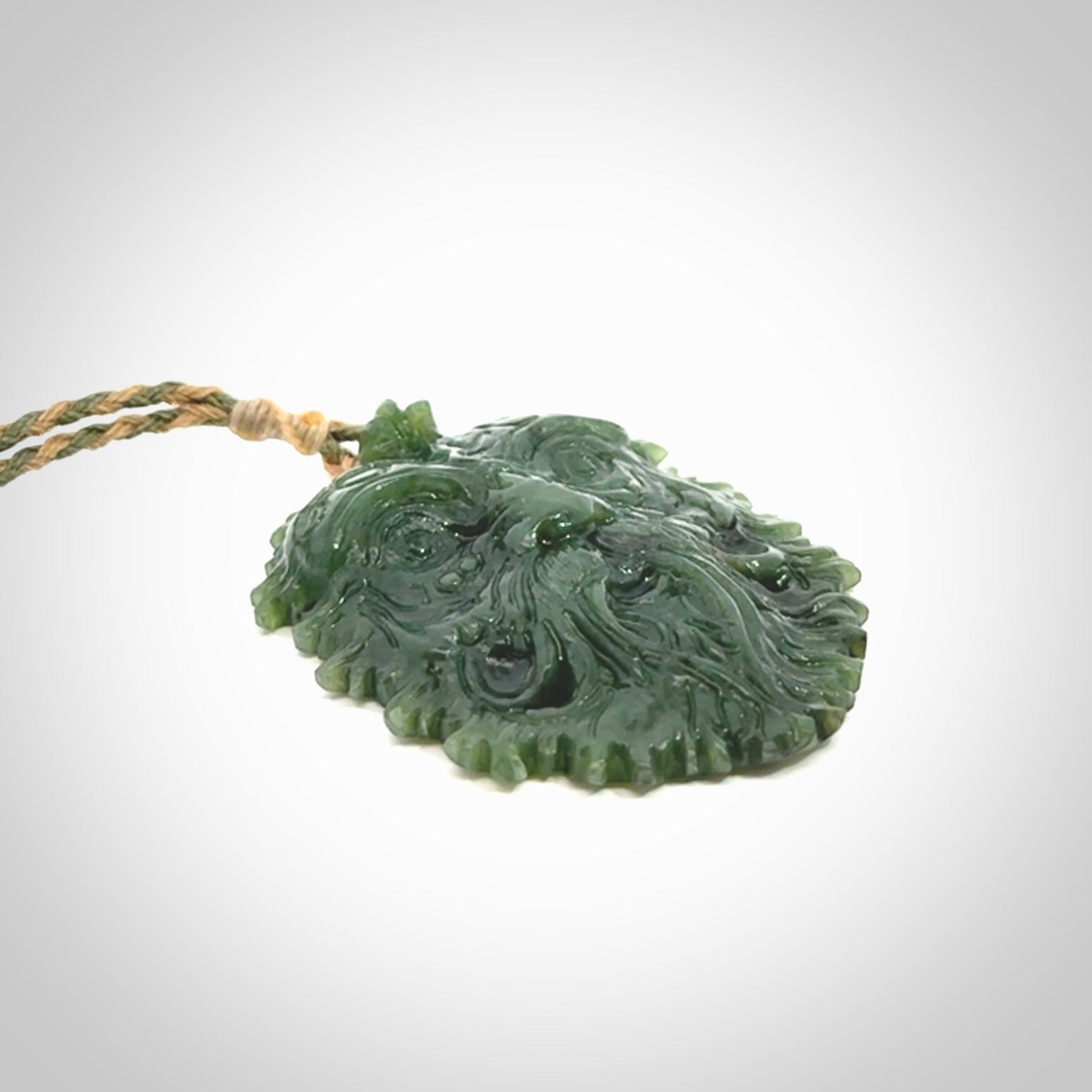 This picture shows a large hand carved forest man face pendant. The cord is hand plaited and adjustable.