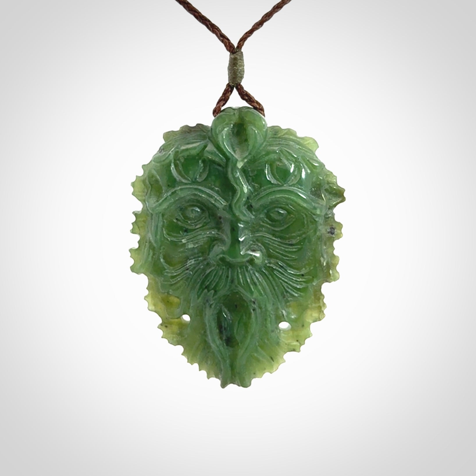 This picture shows a large hand carved forest man face pendant. The cord is hand plaited and adjustable.