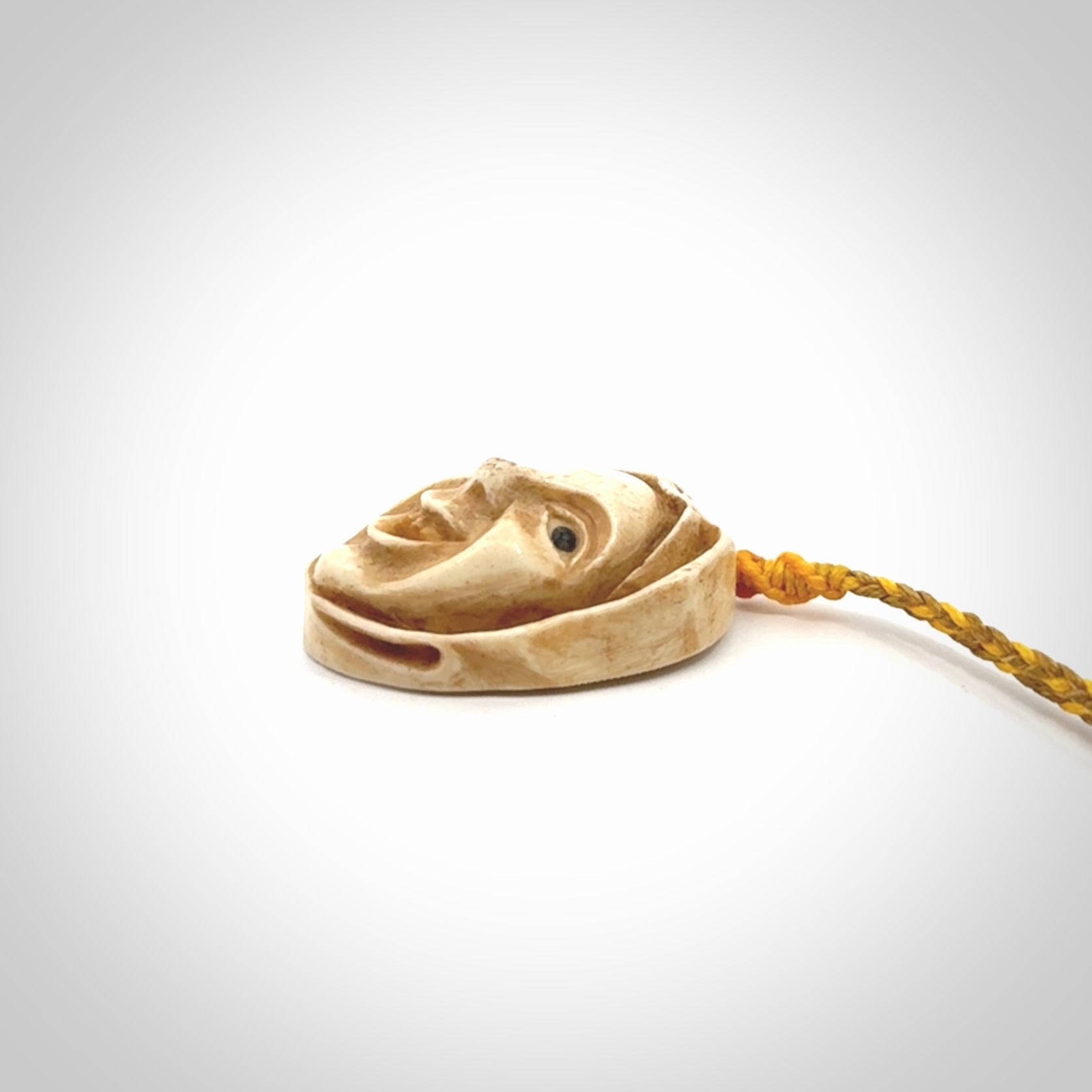 Hand carved incredible stained bone gargoyle face carving. A stunning work of art. This pendant was hand carved in bone with buffalo horn inlay for the eyes by Yuri Terenyi. A one off collectors item that has been hand crafted to be worn or displayed.