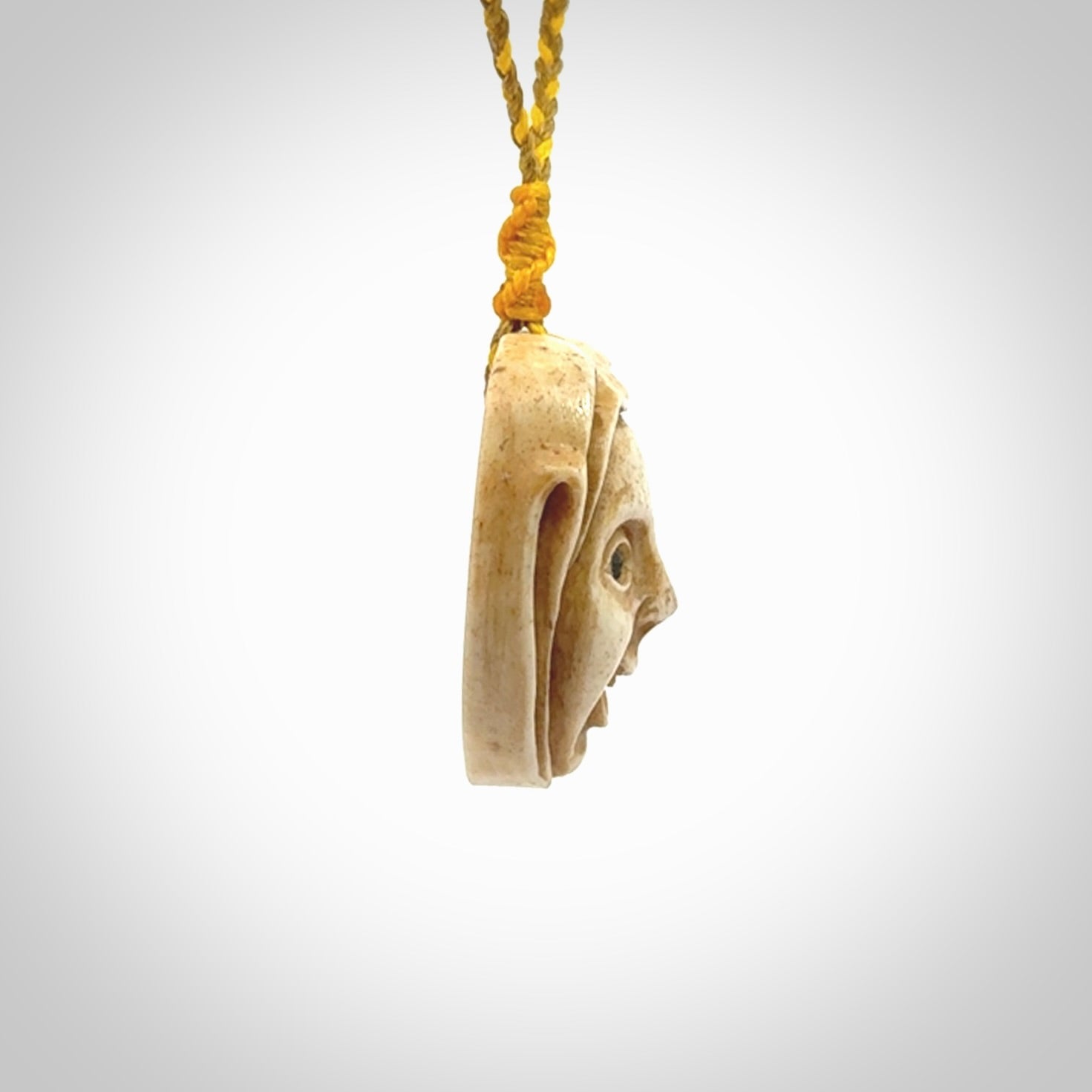 Hand carved incredible stained bone gargoyle face carving. A stunning work of art. This pendant was hand carved in bone with buffalo horn inlay for the eyes by Yuri Terenyi. A one off collectors item that has been hand crafted to be worn or displayed.