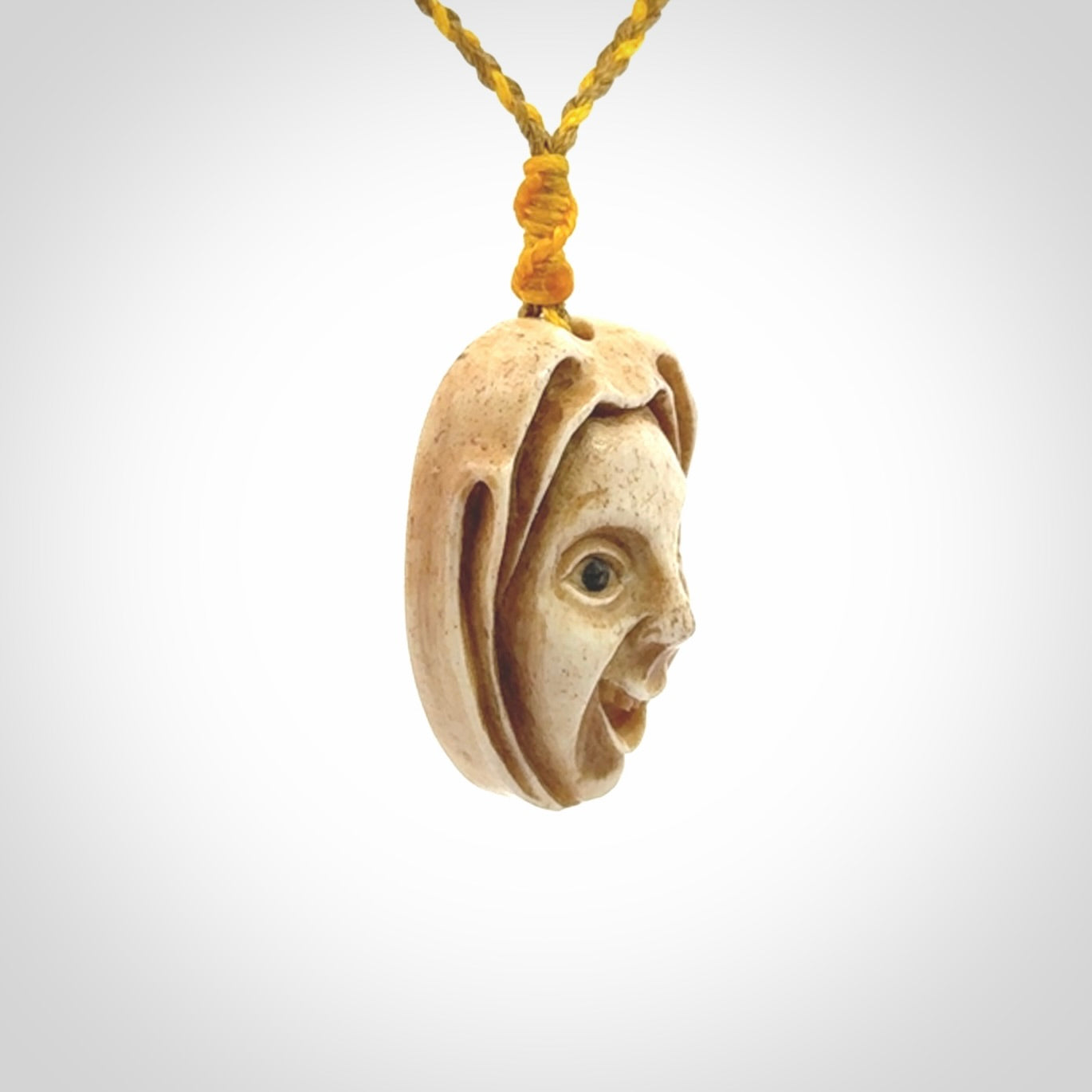 Hand carved incredible stained bone gargoyle face carving. A stunning work of art. This pendant was hand carved in bone with buffalo horn inlay for the eyes by Yuri Terenyi. A one off collectors item that has been hand crafted to be worn or displayed.