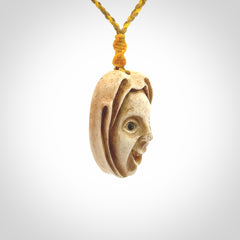Hand carved incredible stained bone gargoyle face carving. A stunning work of art. This pendant was hand carved in bone with buffalo horn inlay for the eyes by Yuri Terenyi. A one off collectors item that has been hand crafted to be worn or displayed.