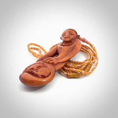 Hand carved stained bone female pendant in a repose shape with her cat. Made from natural bone. Bone jewellery from the Pacific for sale online. Female pendant for men and women.