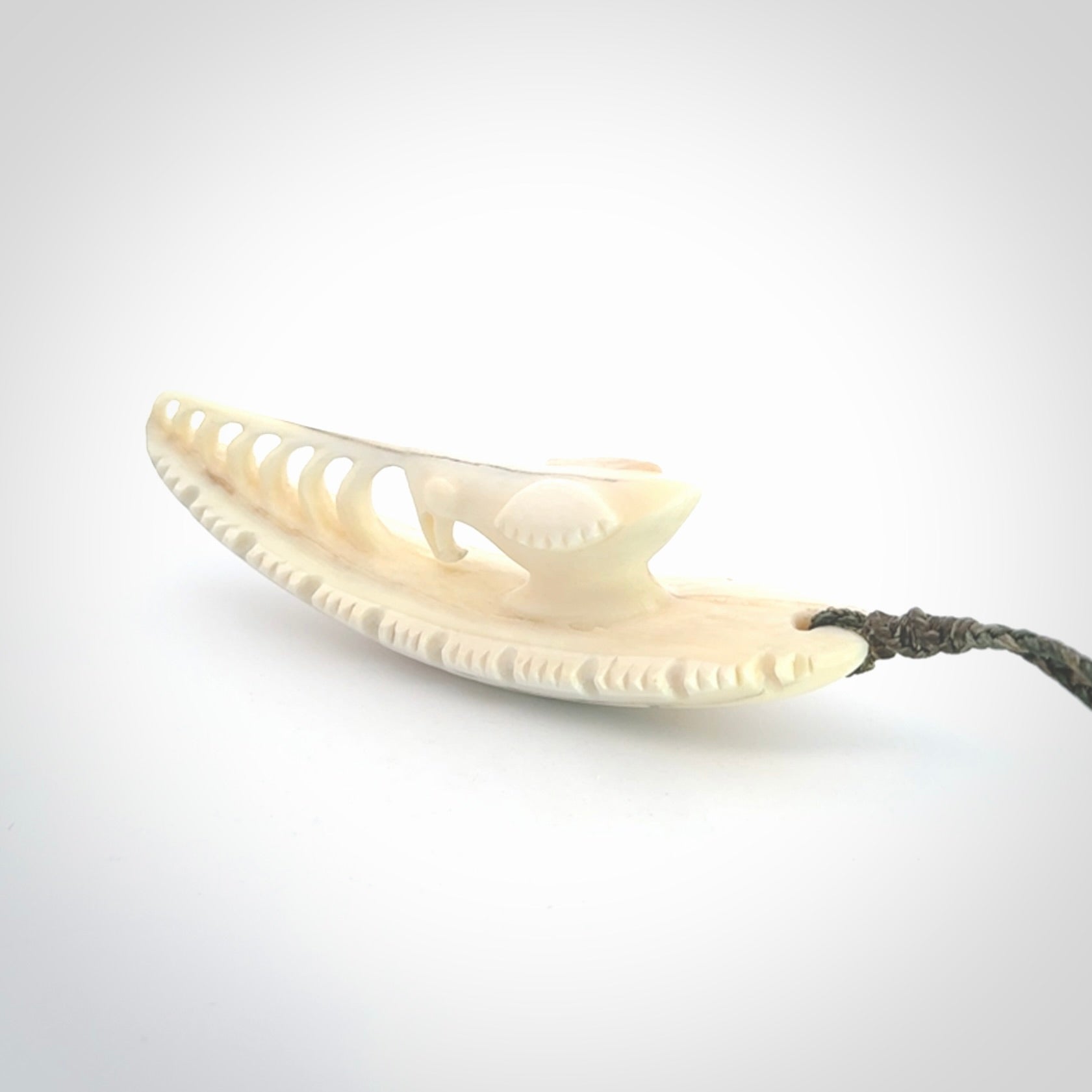 This is a hand carved bone contemporary warthog tusk pendant. Yuri Terenyi has carved this from warthog tusk. It is a delightful, large and artistic piece of jewellery. One only necklace.