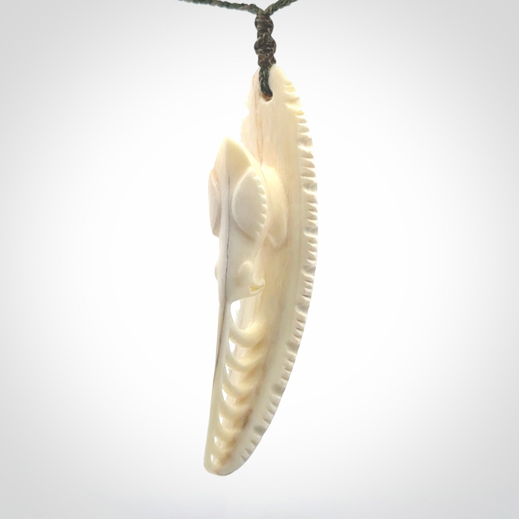 This is a hand carved bone contemporary warthog tusk pendant. Yuri Terenyi has carved this from warthog tusk. It is a delightful, large and artistic piece of jewellery. One only necklace.
