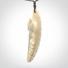 This is a hand carved bone contemporary warthog tusk pendant. Yuri Terenyi has carved this from warthog tusk. It is a delightful, large and artistic piece of jewellery. One only necklace.