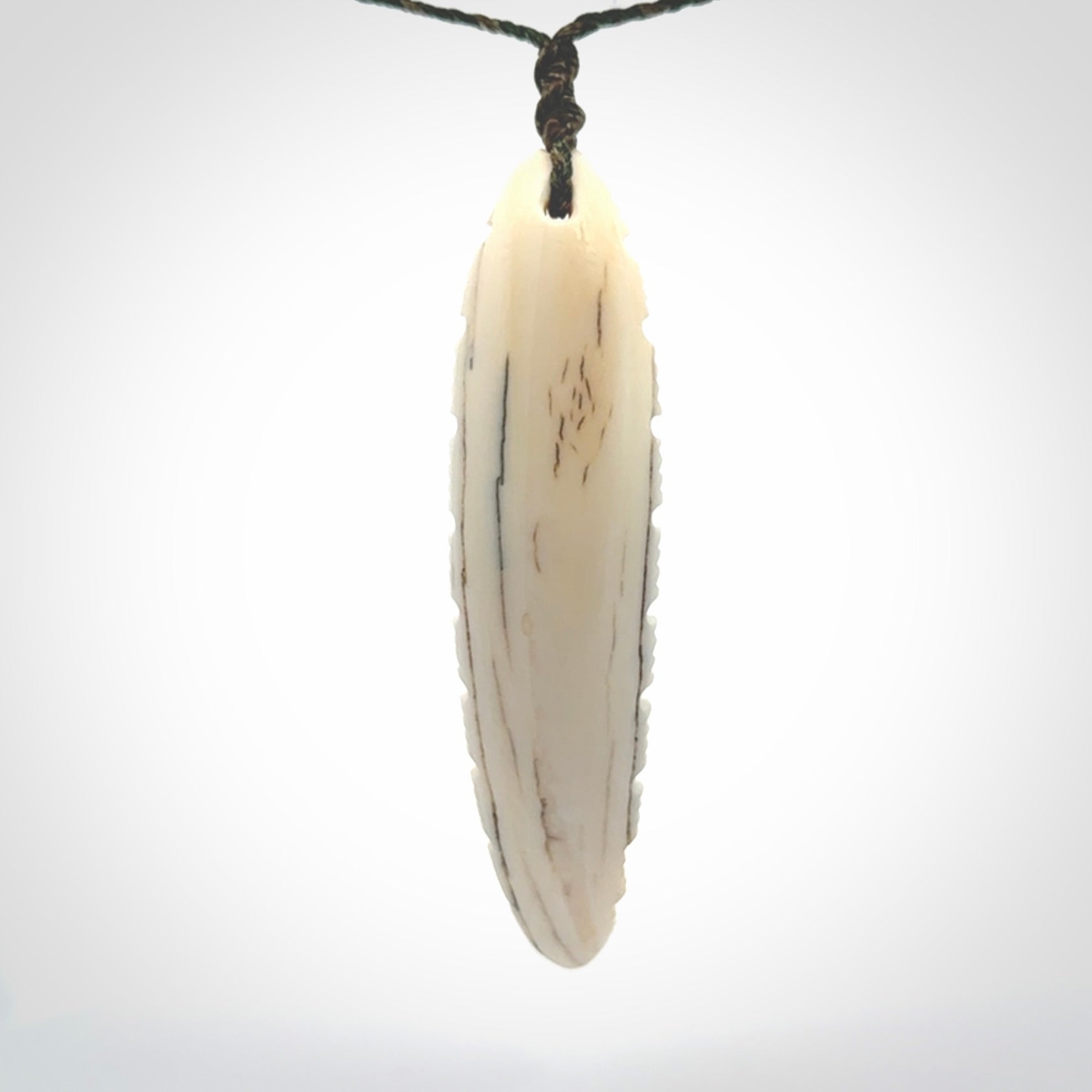 This is a hand carved bone contemporary warthog tusk pendant. Yuri Terenyi has carved this from warthog tusk. It is a delightful, large and artistic piece of jewellery. One only necklace.