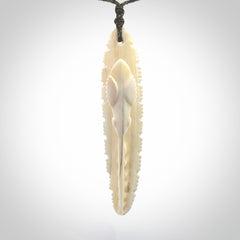 This is a hand carved bone contemporary warthog tusk pendant. Yuri Terenyi has carved this from warthog tusk. It is a delightful, large and artistic piece of jewellery. One only necklace.