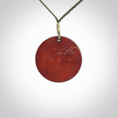 Hand carved natural stained bone contemporary disc pendant with creative and unique carvings on the front face of each individual piece.