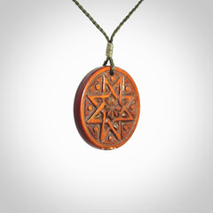 Hand carved natural stained bone contemporary disc pendant with creative and unique carvings on the front face of each individual piece.