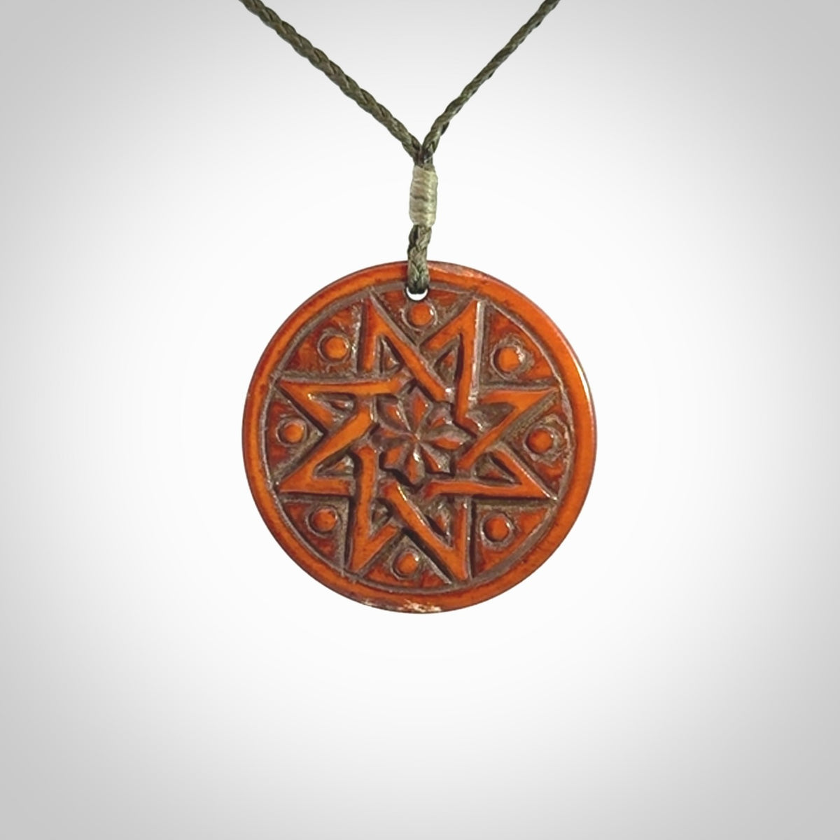 Hand carved natural stained bone contemporary disc pendant with creative and unique carvings on the front face of each individual piece.