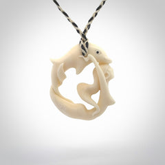 This pendant is a gorgeous and intricately carved mermaid with dolphin pendant. Carved by renowned bone carver Yuri Terenyi for us. This is a little masterpiece. It is a mermaid with her arms clasped around a dolphin. The craftsmanship displayed in this piece is extraordinary - a collectors item, or a piece to wear and love.