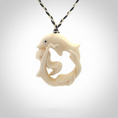 This pendant is a gorgeous and intricately carved mermaid with dolphin pendant. Carved by renowned bone carver Yuri Terenyi for us. This is a little masterpiece. It is a mermaid with her arms clasped around a dolphin. The craftsmanship displayed in this piece is extraordinary - a collectors item, or a piece to wear and love.