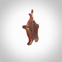 Hand carved bone starfish pendant. Ocean themed pendants carved by NZ Pacific. Moana pendants for sale online. Hand made stained bone sea star by Yuri Terenyi. We provide these starfish on adjustable cords. Postage is included in the price.