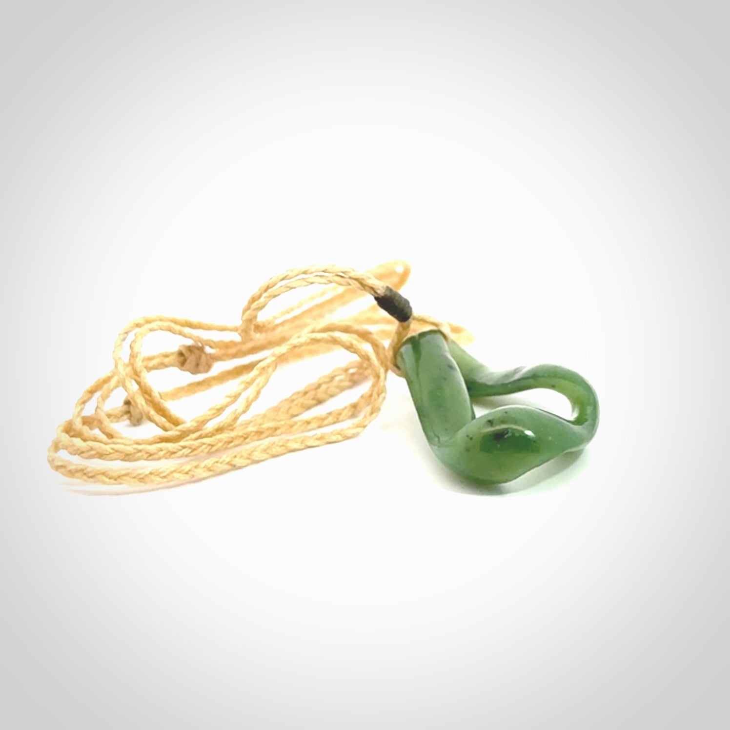 This little piece is a hand carved möbius ribbon pendant. We've carved this from Nephrite Jade. It has very subtle colour variations in the stone and is a delightful, small and artistic piece of jewellery.