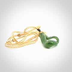 This little piece is a hand carved möbius ribbon pendant. We've carved this from Nephrite Jade. It has very subtle colour variations in the stone and is a delightful, small and artistic piece of jewellery.
