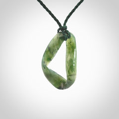 This little piece is a hand carved möbius ribbon pendant. We've carved this from Nephrite Jade. It has very subtle colour variations in the stone and is a delightful, small and artistic piece of jewellery.