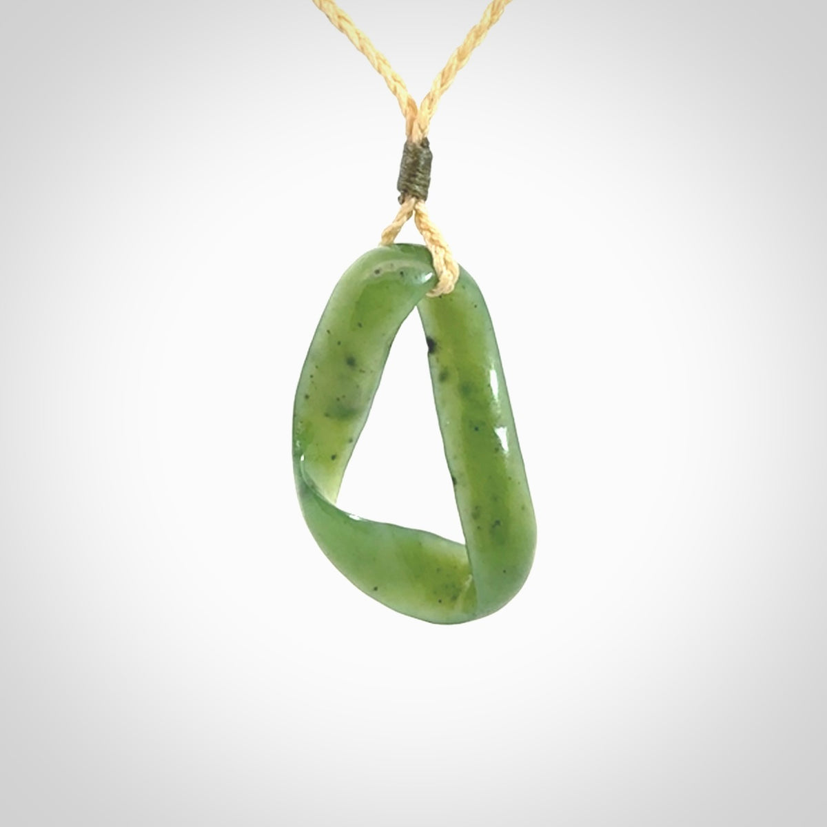 This little piece is a hand carved möbius ribbon pendant. We've carved this from Nephrite Jade. It has very subtle colour variations in the stone and is a delightful, small and artistic piece of jewellery.