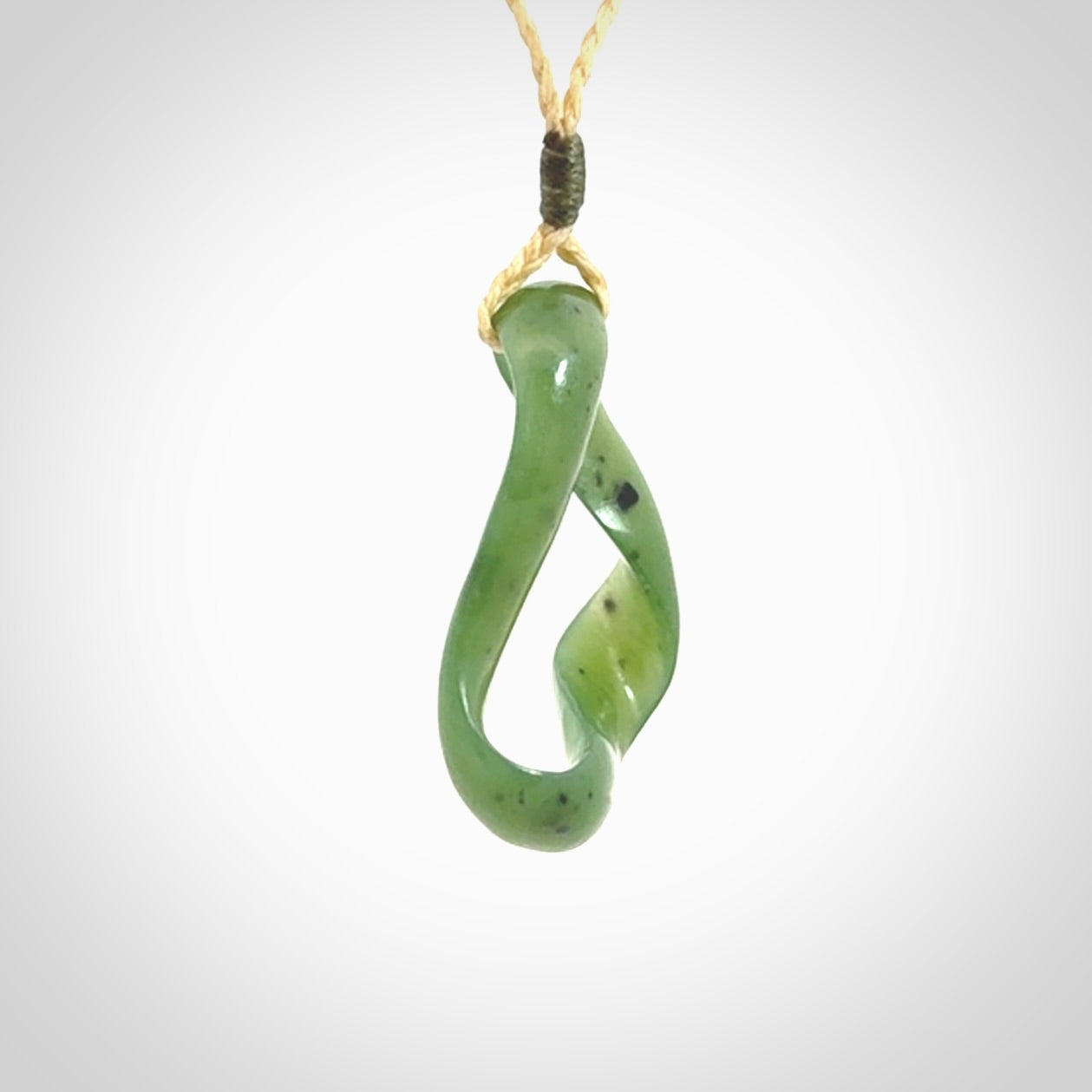 This little piece is a hand carved möbius ribbon pendant. We've carved this from Nephrite Jade. It has very subtle colour variations in the stone and is a delightful, small and artistic piece of jewellery.