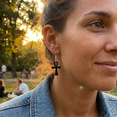 woman wearing black jade ankh cross earrings