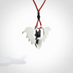 This is a hand carved bat pendant. It is made from Black Jade and Sterling Silver. This is a medium sized necklace and is a very unique, one only, pendant that is a collectors piece. Provided with red adjustable cord.