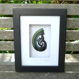 A hand carved large New Zealand Jade koru necklace that has been framed and signed by artist Kerry Thompson. A large sized hand made koru necklace by New Zealand artist Kerry Thompson. One off framed work of art to wear. Delivered with Express Courier.