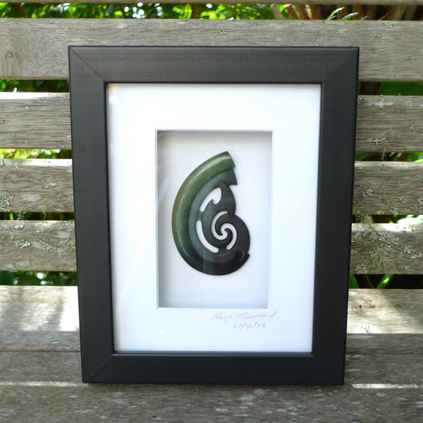 A hand carved large New Zealand Jade koru necklace that has been framed and signed by artist Kerry Thompson. A large sized hand made koru necklace by New Zealand artist Kerry Thompson. One off framed work of art to wear. Delivered with Express Courier.