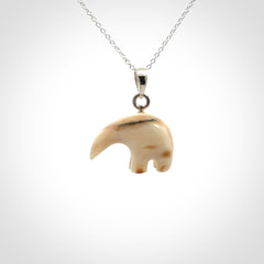 Hand made woolly mammoth tusk sea bear necklace with Sterling Silver. Mammoth tusk polar bear pendant with Sterling silver surround and chain. Made by NZ Pacific and sale online only.