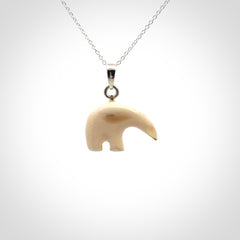 Hand made woolly mammoth tusk sea bear necklace with Sterling Silver. Mammoth tusk polar bear pendant with Sterling silver surround and chain. Made by NZ Pacific and sale online only.