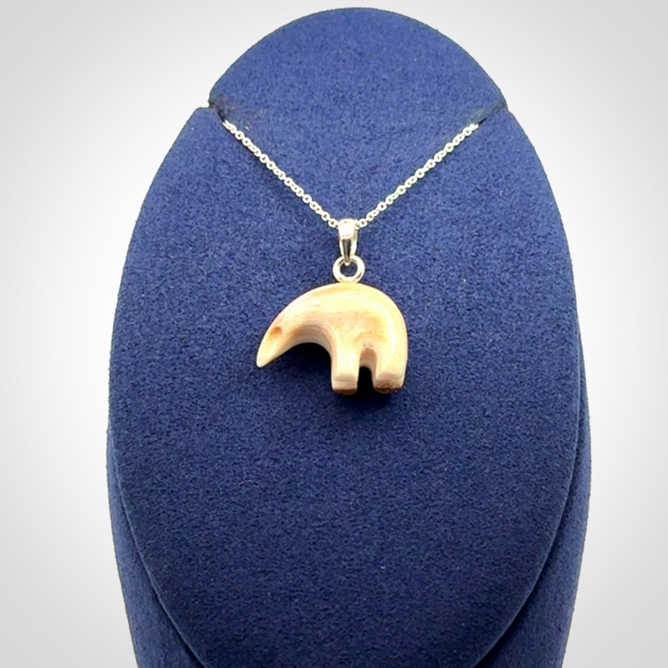 Hand made woolly mammoth tusk sea bear necklace with Sterling Silver. Mammoth tusk polar bear pendant with Sterling silver surround and chain. Made by NZ Pacific and sale online only.