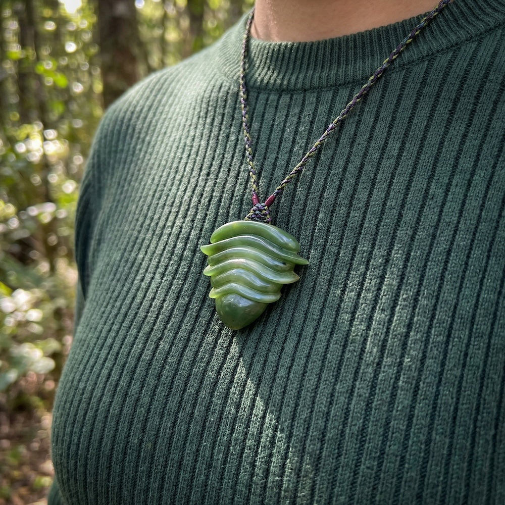 person wearing jade pendant