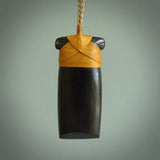 This photo shows wooden toki pendants. The cord is length adjustable which allows the pendant to be positioned where it suits you best. The toki was carved for us in hard wood. Unique art to wear.
