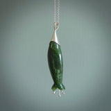 A photo of a harakeke, or flax flower, carved from a colourful piece of New Zealand flower jade. The cap and stamens are made from Sterling Silver and the cord is an Olive braid which is length adjustable.