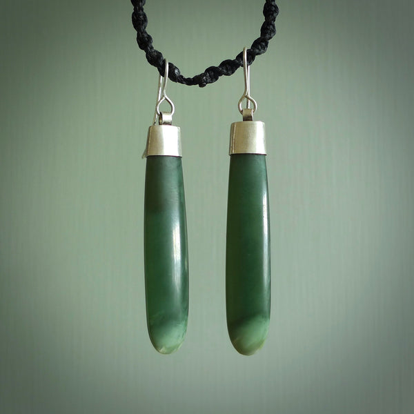These are stunning Inanga jade drop earrings carved in New Zealand by Josey Coyle. They are carved from a light minty green piece of New Zealand Inanga Jade and with Sterling Silver caps, hooks and findings.
