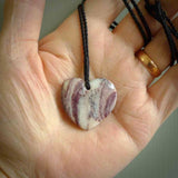 A hand carved heart pendant made from New Zealand Rhodonite Stone. This is a medium sized and visually striking piece, beautifully curved and sensuous. The perfect piece of jewellery for someone you love.