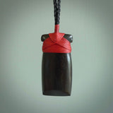 This photo shows wooden toki pendants. The cord is length adjustable which allows the pendant to be positioned where it suits you best. The toki was carved for us in hard wood. Unique art to wear.