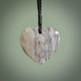 A hand carved heart pendant made from New Zealand Rhodonite Stone. This is a medium sized and visually striking piece, beautifully curved and sensuous. The perfect piece of jewellery for someone you love.