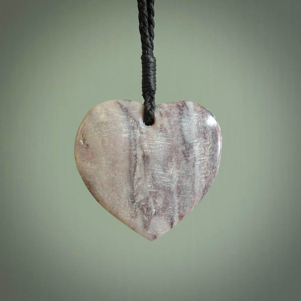 A hand carved heart pendant made from New Zealand Rhodonite Stone. This is a medium sized and visually striking piece, beautifully curved and sensuous. The perfect piece of jewellery for someone you love.