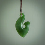 This matau is carved from a very striking New Zealand  jade. It is both intricate and simple in design - it has hidden folds and smooth curves. A piece to be worn or displayed - the carving and the jade are both magnificent. One only jade hook necklace hand made by Ric Moor.
